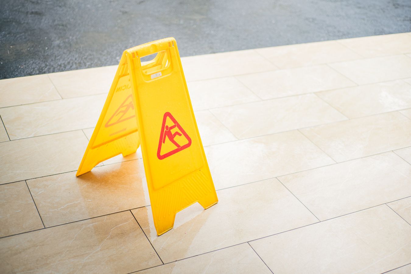 wet floor warning sign at site of slip and fall accident
